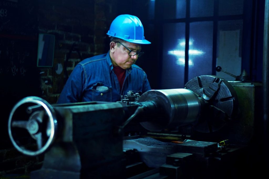 man working on machine in a factory is a great example of what the value of labour day is