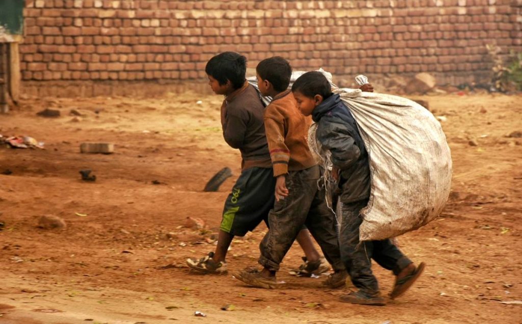 children carrying garbage sacks social issues in the world