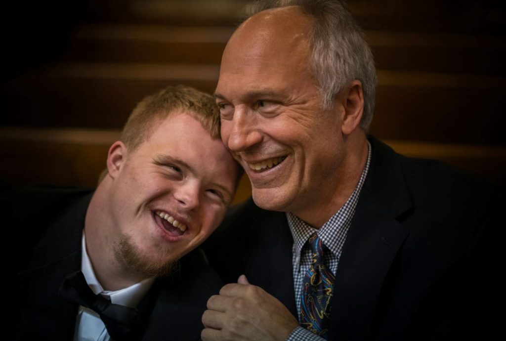 father and son smiling after helping parents cope with a child's diagnosis