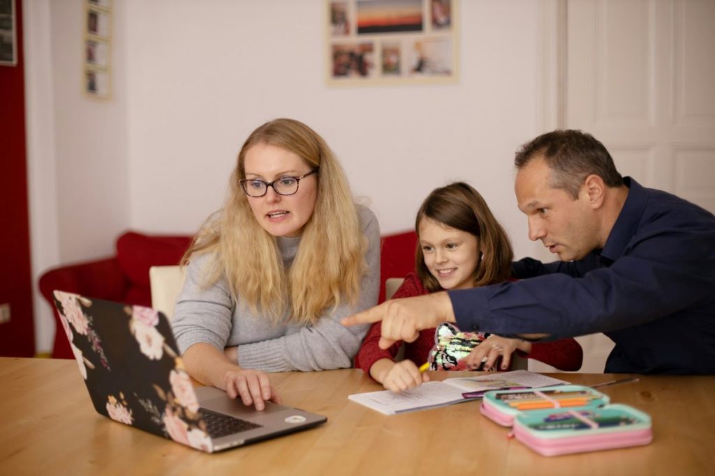 mother and father looking at laptop helping parents cope with a child's diagnosis