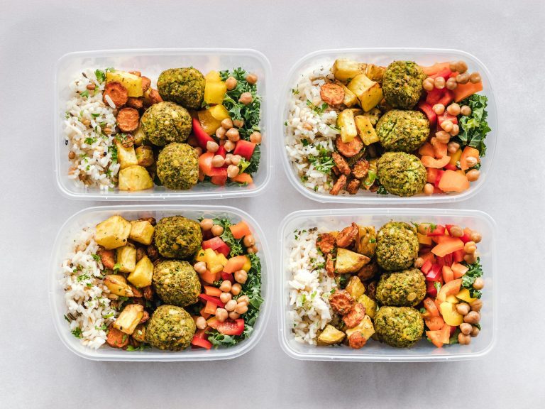 Easy & healthy meal boxes full of nutritious food on a white table.