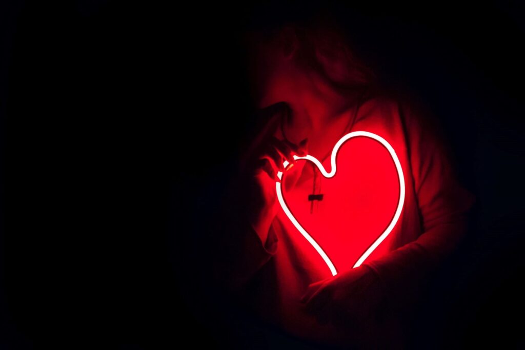 woman holding lights heart