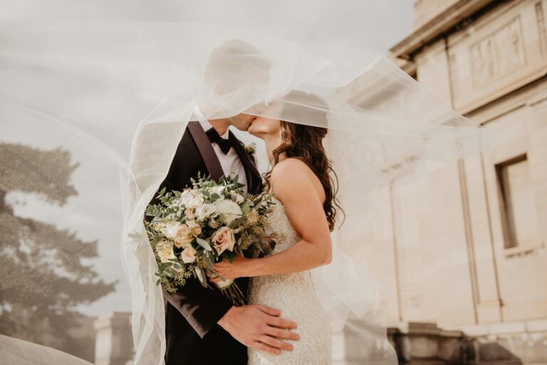 A couple kissing on their wedding day, which is the start of the journey to a perfect marriage.