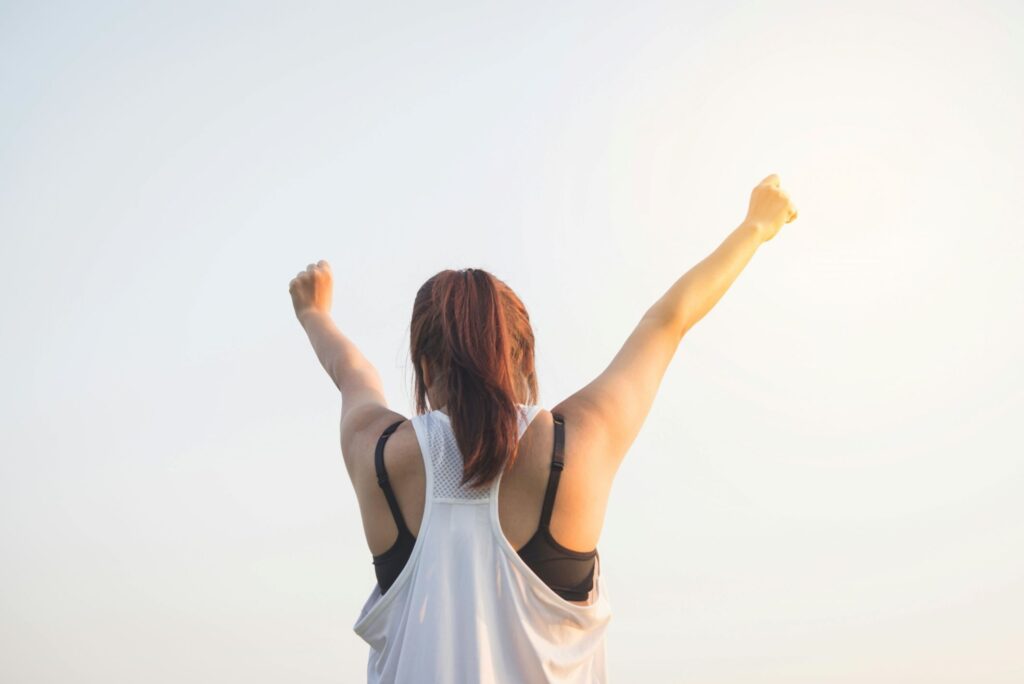 a woman raising her two hands