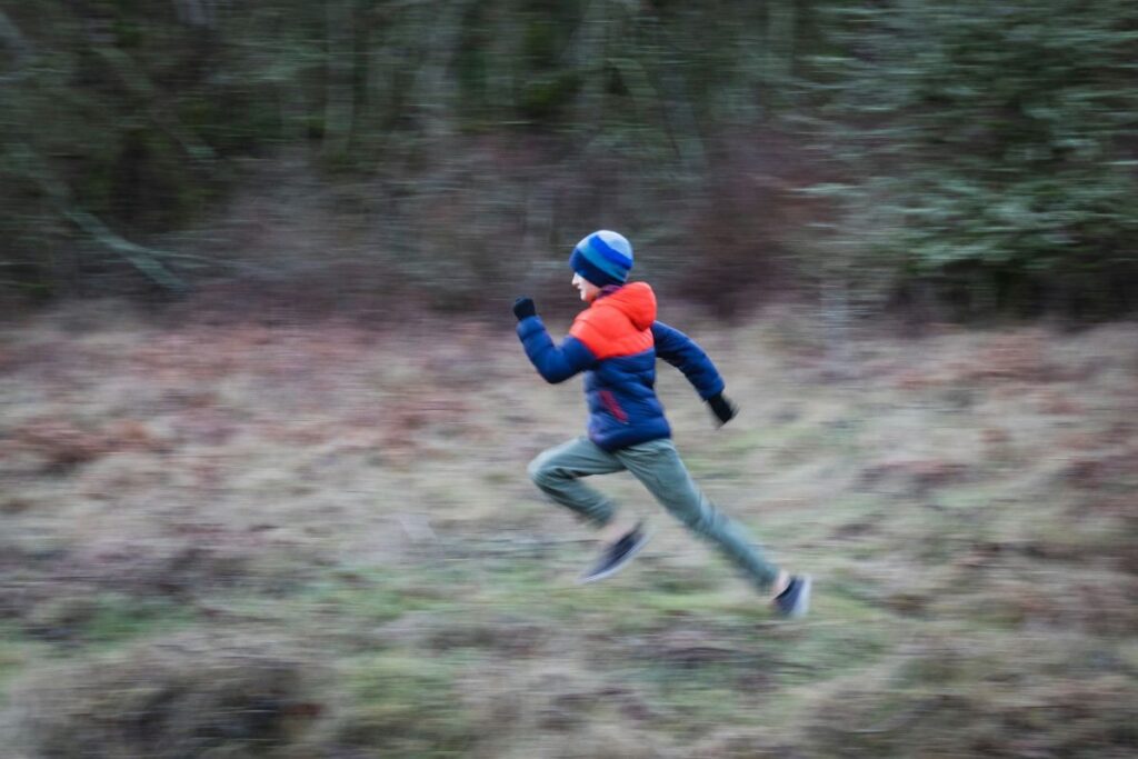 image of a child running so fast the background is blurred tells us why kids need exercise to move quickly