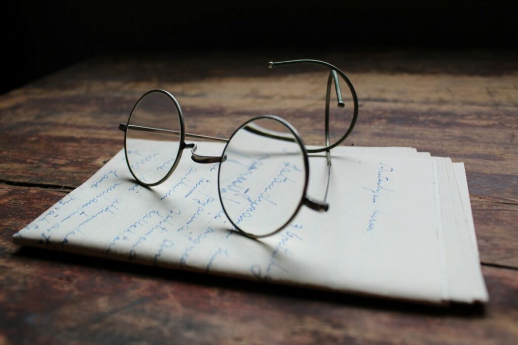 a photo of a letter with glasses on top