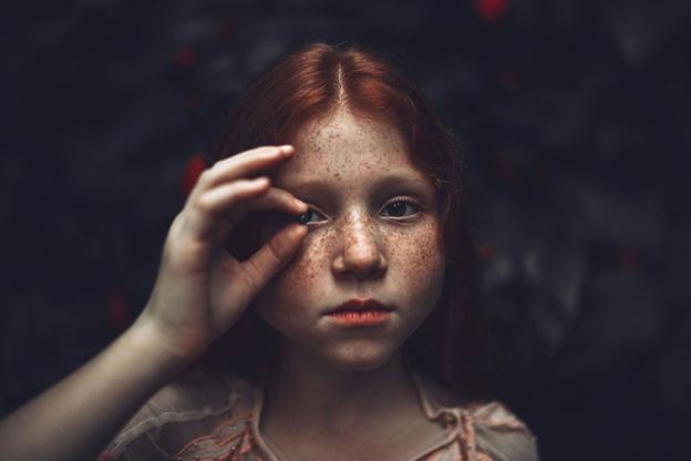 A ginger-haired girl with freckles across her face.