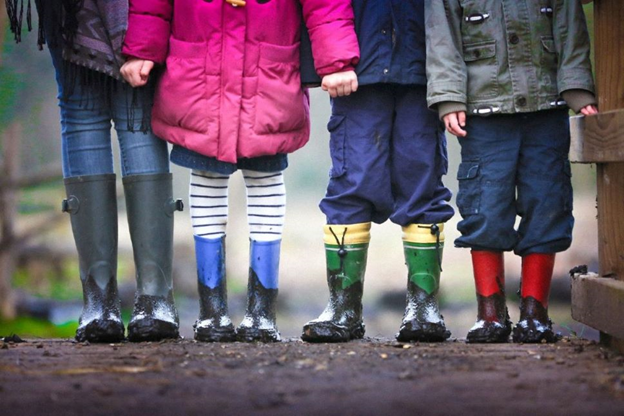 Four children wearing boots.