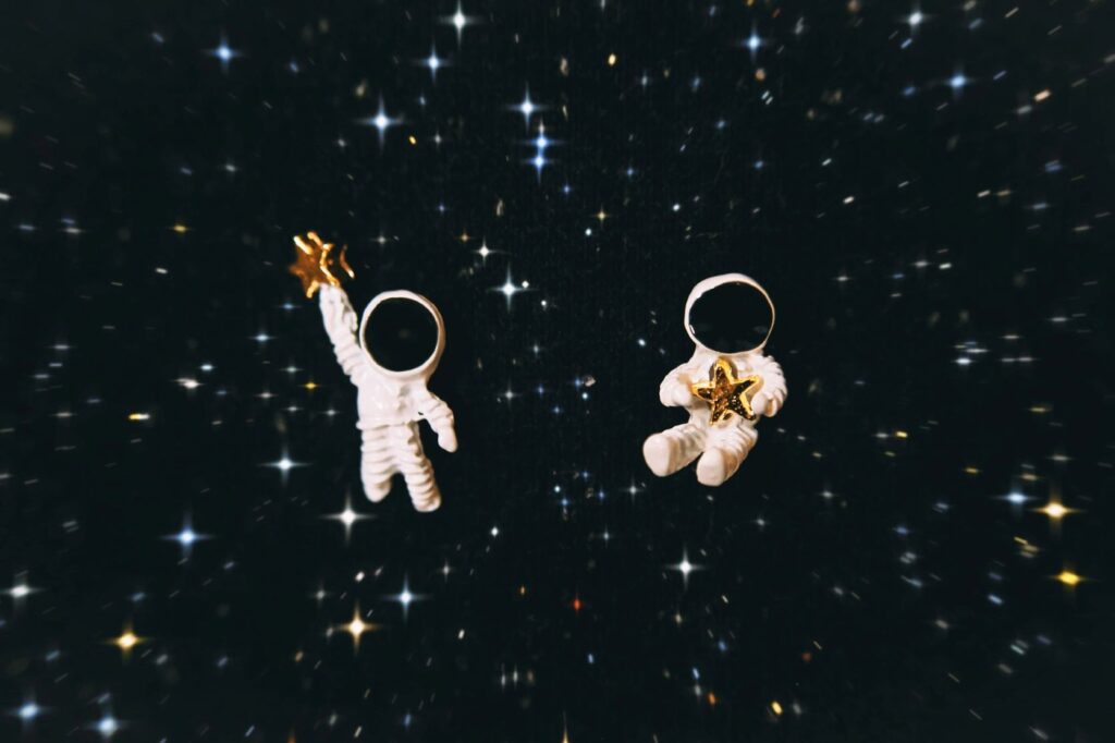 Two astronaut dolls in the middle of space