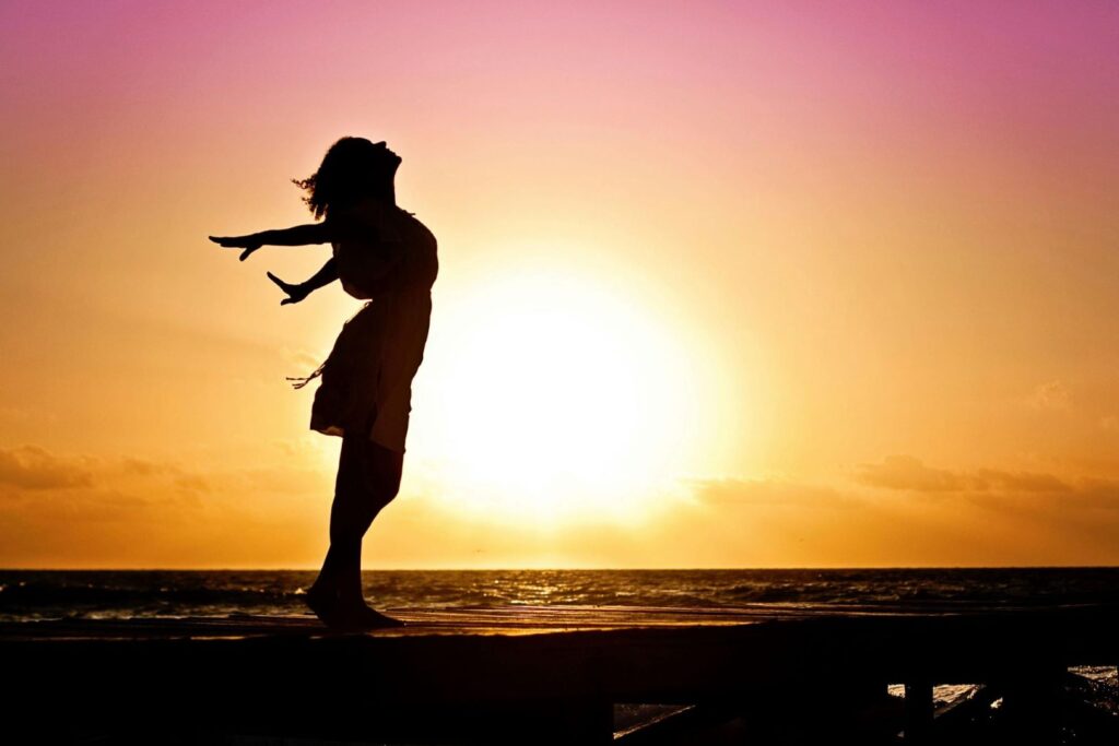 A woman silhouetted by the sun