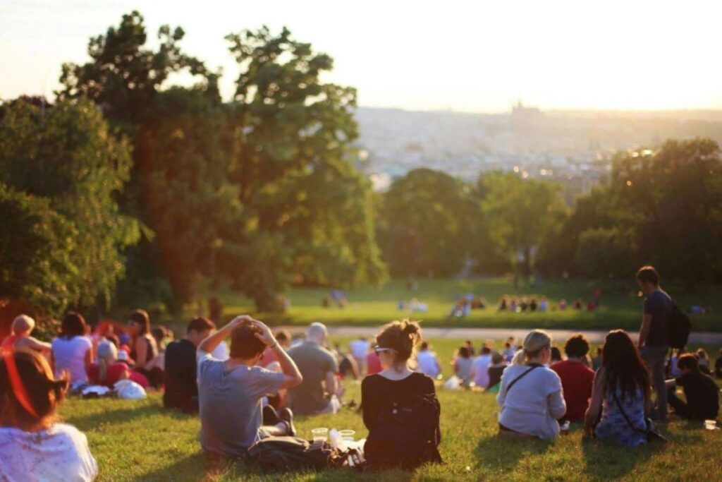 A crowd scattered in a park.