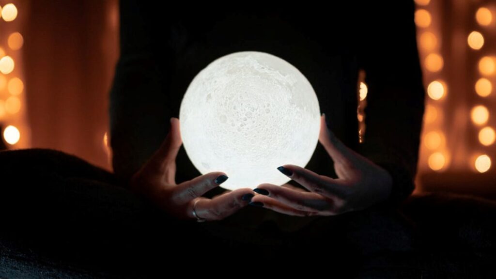 image of a woman holding a glowing crystal ball to metaphorically show what psychic reading is