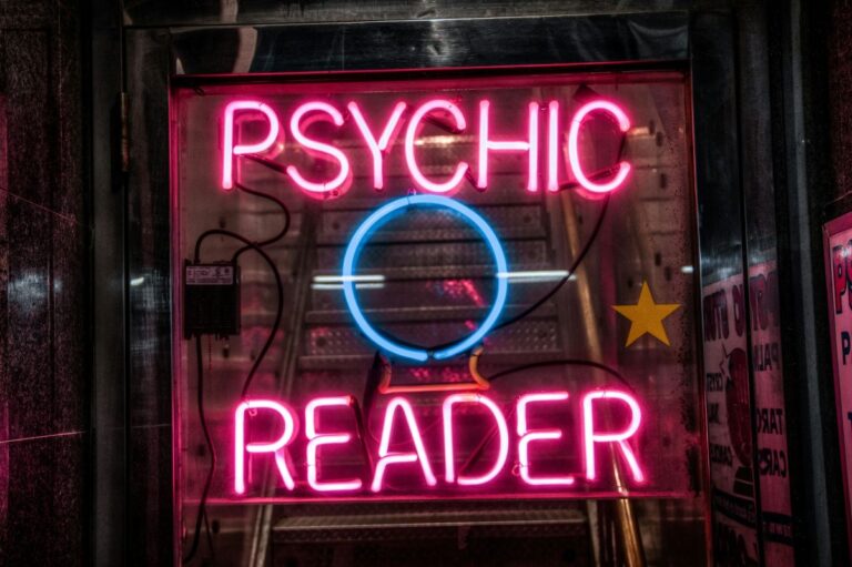 image of neon light signs reading “psychic reader” depicting what is psychic reading