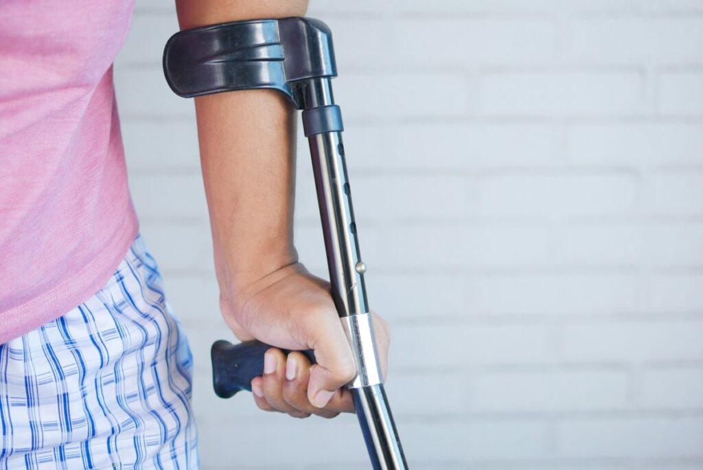 image of a person using crutches show how managing physical injuries look like