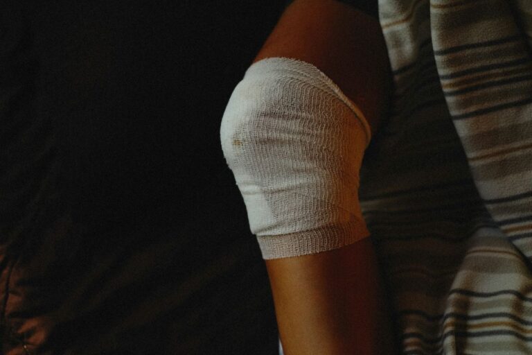 image of woman with gauze in her elbow depicting the right way to managing physical injuries