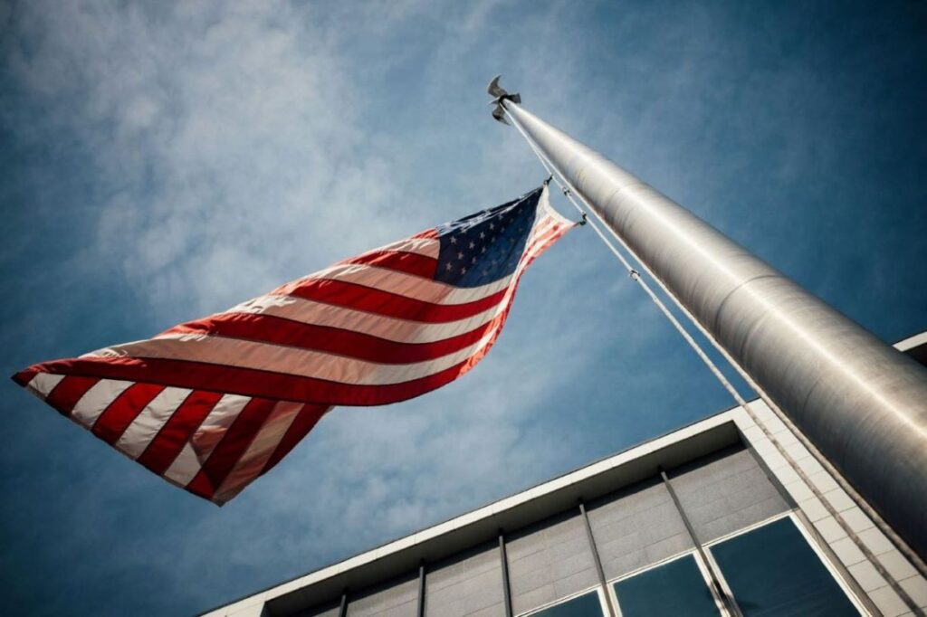 The American flag halfway through its pole.