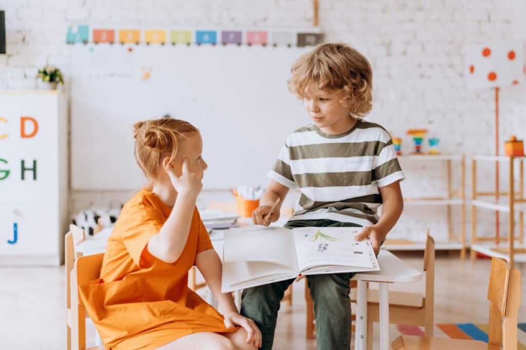 Two kids reading a book