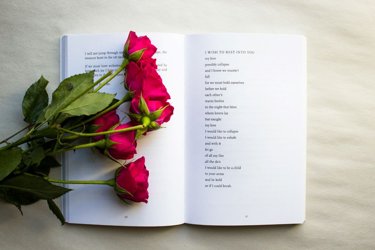 image of poetry book with flower on top its pages showing one of the inspirational poetry books to read