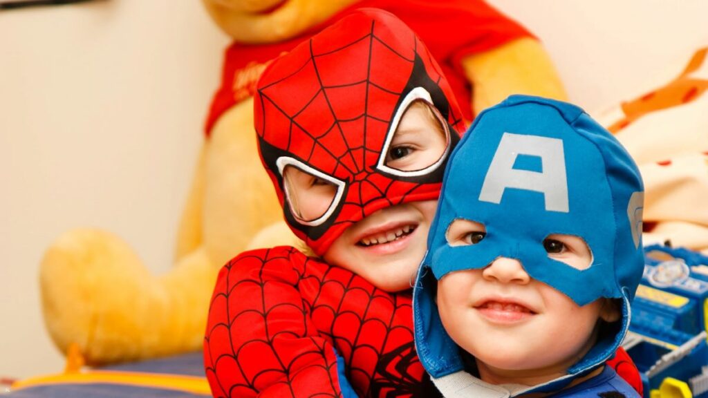 image of two kids wearing spiderman and captain America costumes showing the value of entertaining why a child needs to dream big