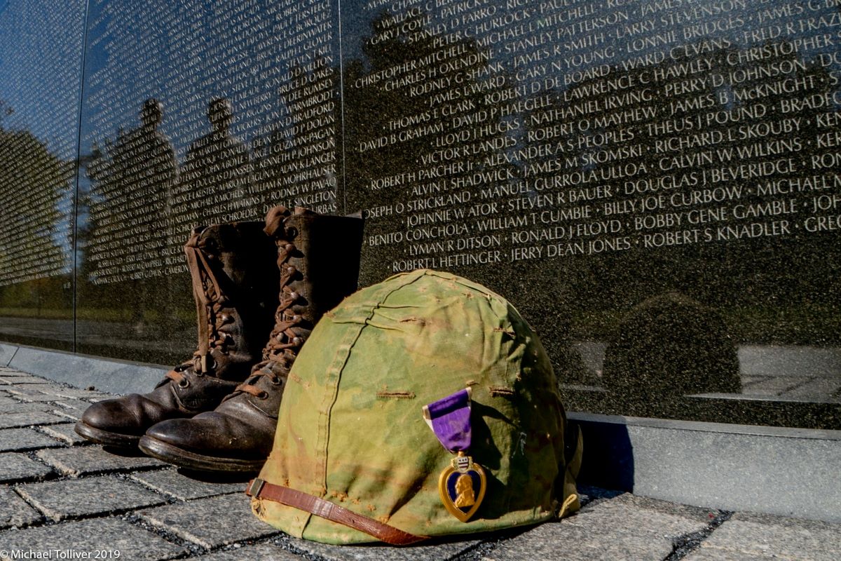 image of the memorial plaque with boots and a helmet portraying homelessness among veterans