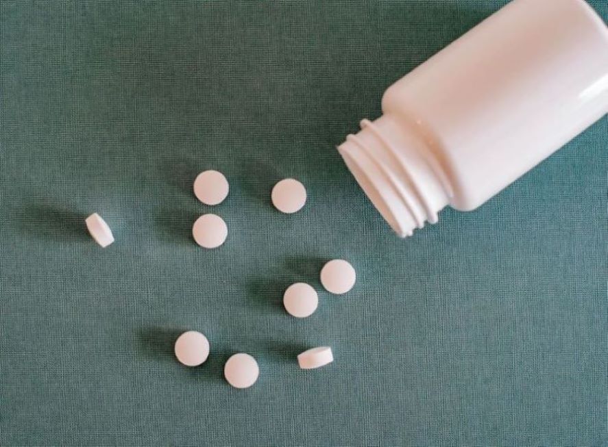 Pills spilling out of a pill bottle.