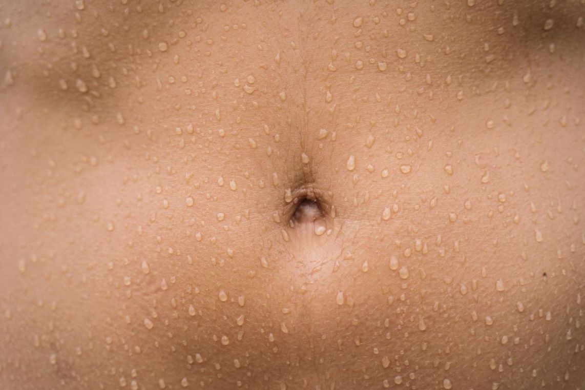 A close-up of a sweaty abdomen.