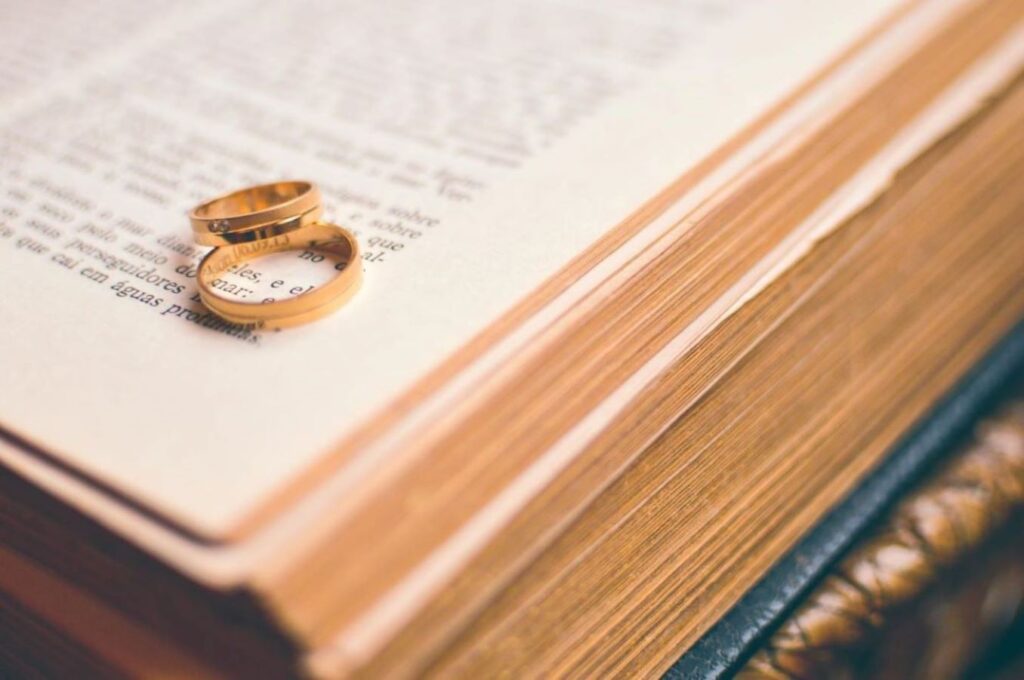 A pair of wedding rings on a book.