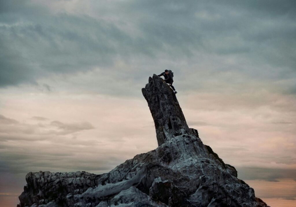 A man climbing a steep mountain face.