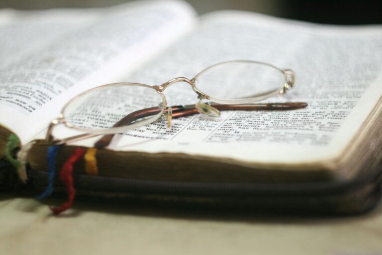 A pair of glasses on a Bible.