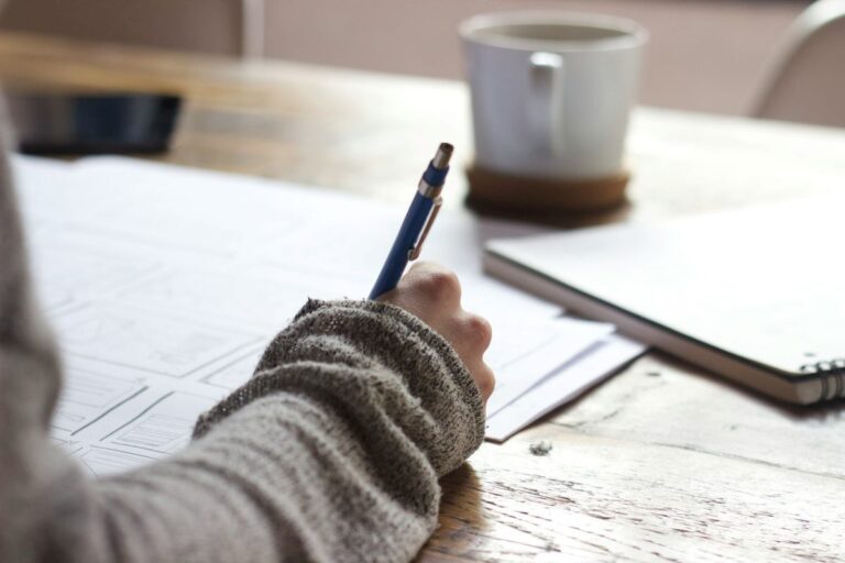 a photo of a person writing, using testimony to spread the word