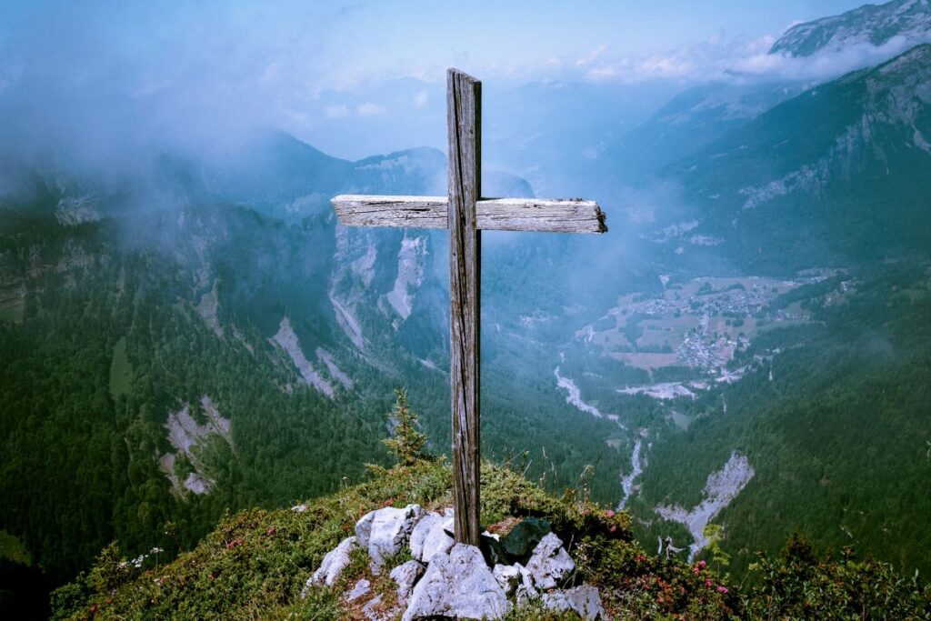 a wooden cross on top of the mountain