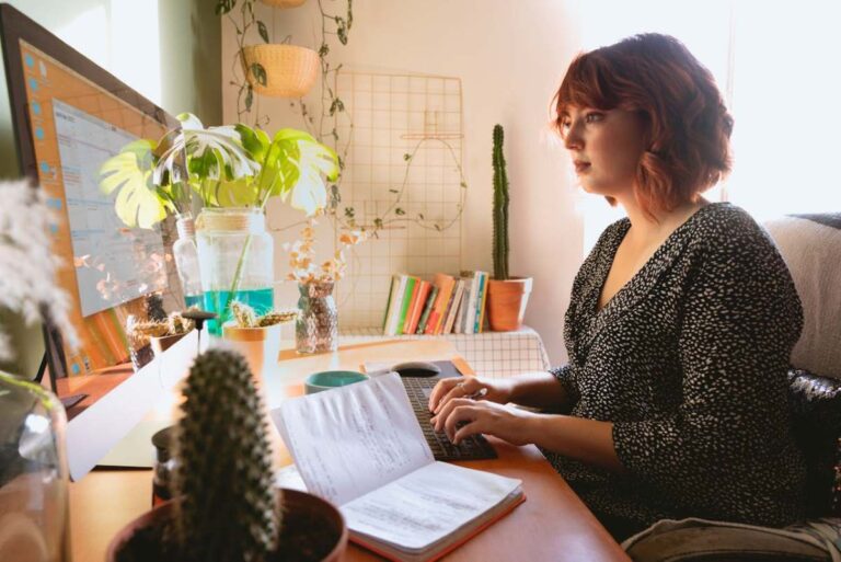 photo of a woman on her computer looking through virtual book event ideas