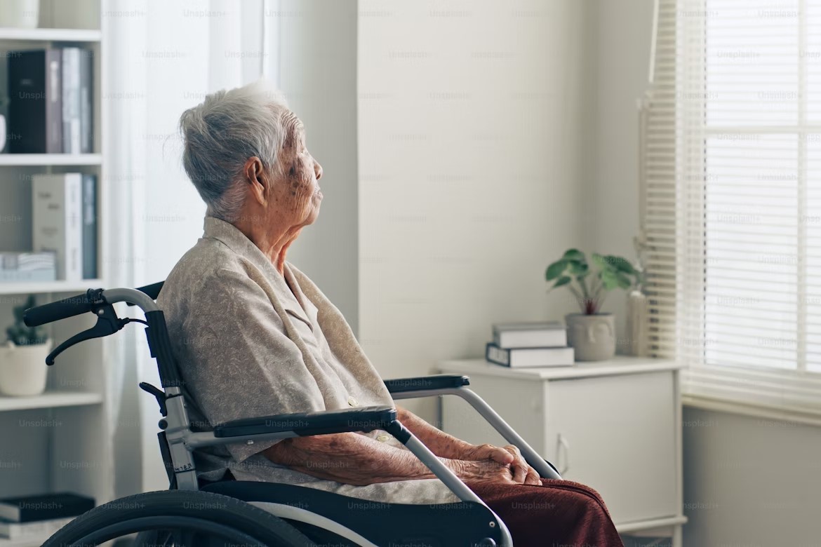 elderly woman staring out the window